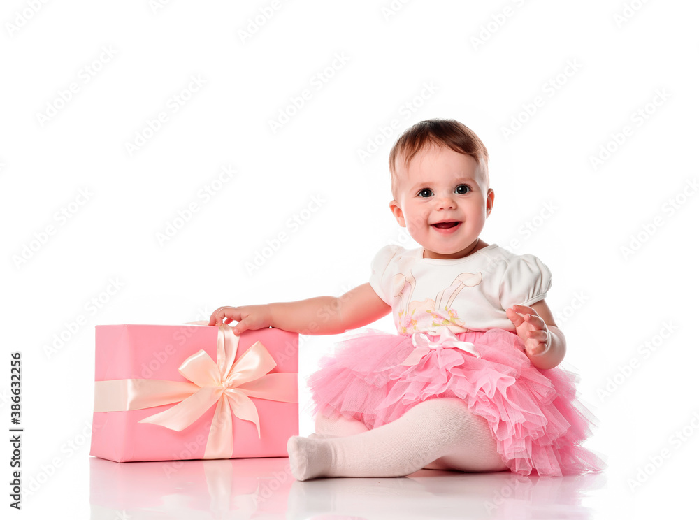 girl sitting on the floor with a gift box and smiling. girl sitting on the floor with a gift box and smiling.