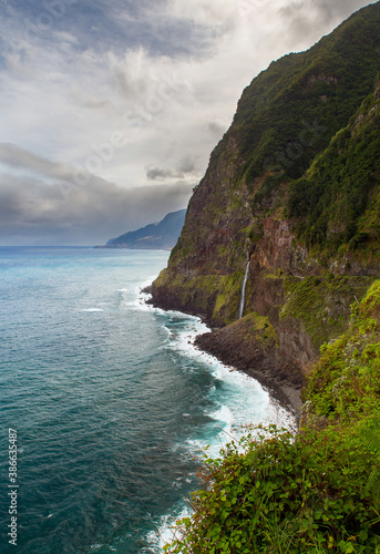 Coastal scenery from veu-de-noiva viewpoint in Seixal district for old coastal road with waterfall and steep cliffs in Madeira island, Portugal