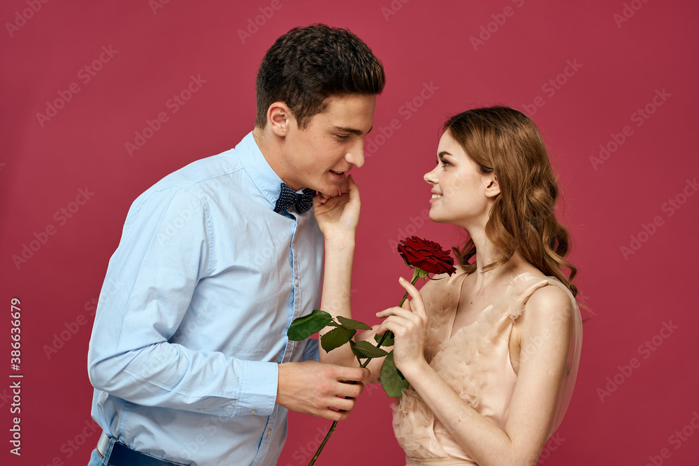 portrait of romantic couple in love with red rose on isolated background and classic suit evening dress portrait of romantic couple in love with red rose on isolated background and classic suit evening dress