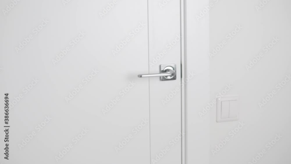 The light inter-room door slowly opens, the handle turns down The light inter-room door slowly opens, the handle turns down