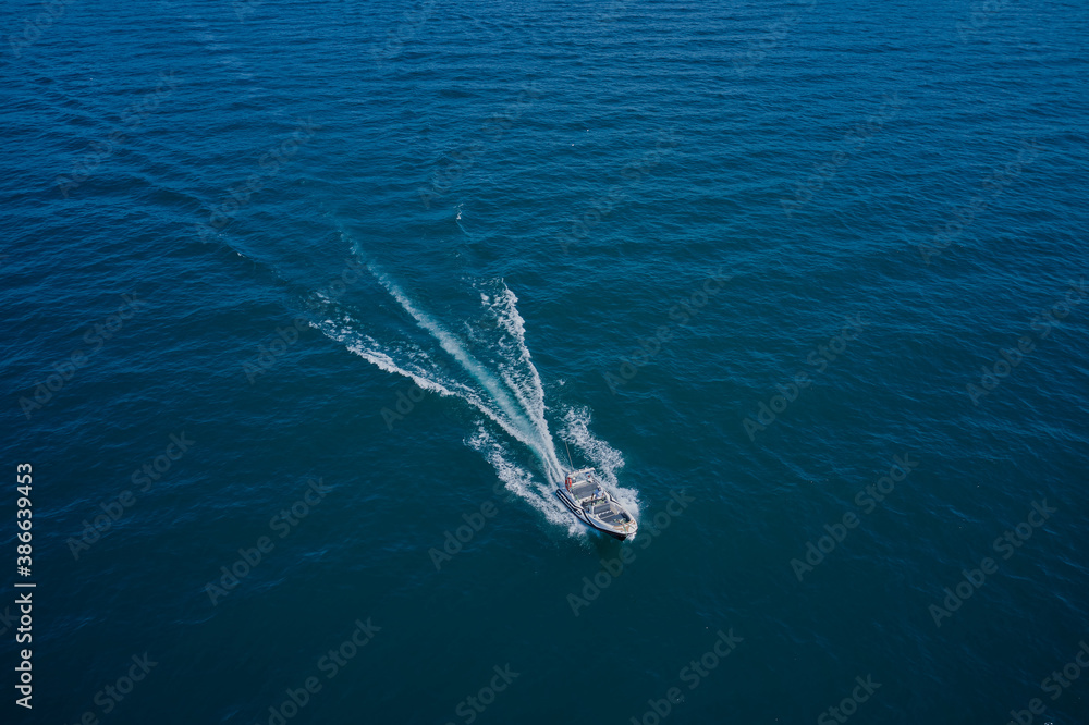 Top view of a white boat sailing in the blue sea. Motor boat in the sea.Travel - image