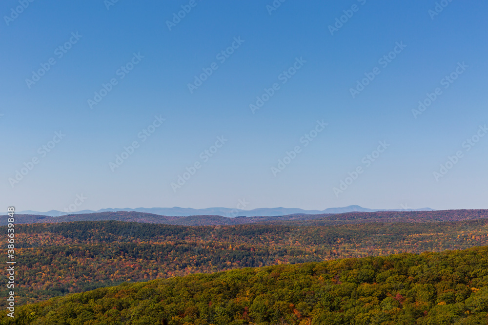Colorful Autumn vistas of mountains and valleys. Yellow, orange and red leaves glisten in the sunshine- 5