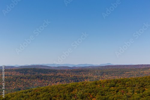 Colorful Autumn vistas of mountains and valleys. Yellow, orange and red leaves glisten in the sunshine- 5