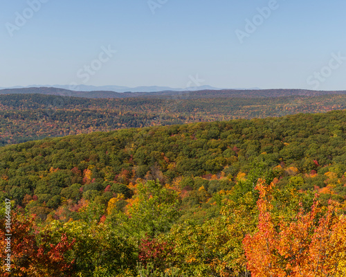Colorful Autumn vistas of mountains and valleys. Yellow, orange and red leaves glisten in the sunshine- 3