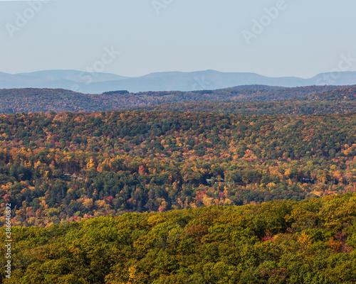 Colorful Autumn vistas of mountains and valleys. Yellow, orange and red leaves glisten in the sunshine- 2