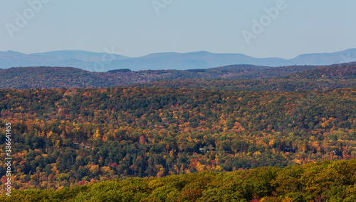 Colorful Autumn vistas of mountains and valleys. Yellow, orange and red leaves glisten in the sunshine- 1
