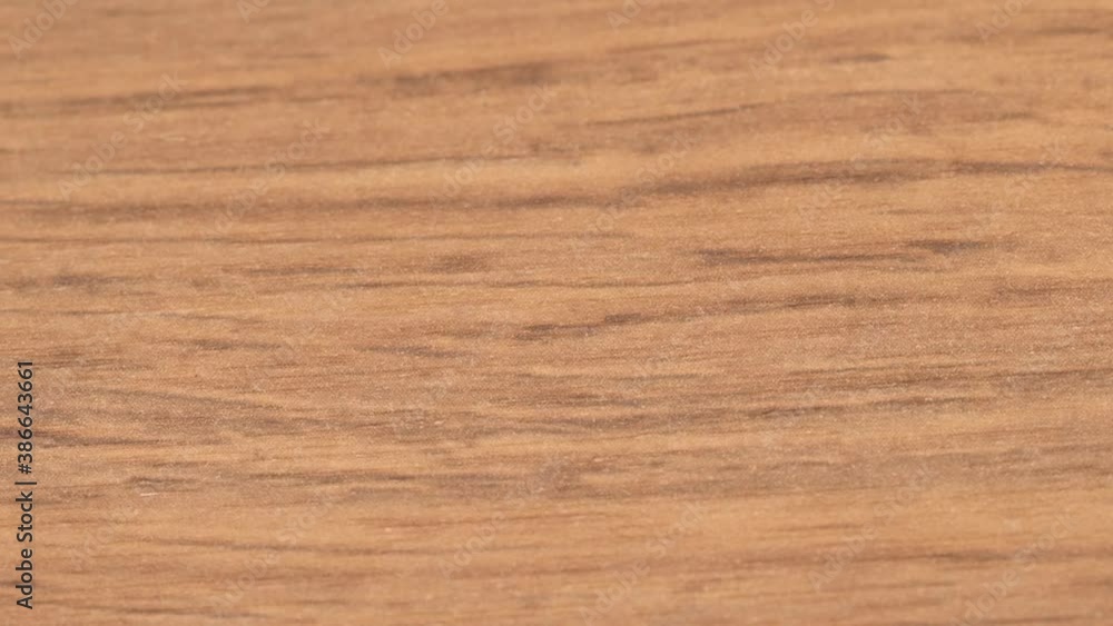 Closeup shot of the wood grain pattern of wood table. Camera panning over it. Closeup shot of the wood grain pattern of wood table. Camera panning over it.