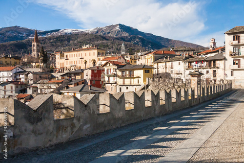 Scenic view of Dronero town with snow on the mountains in Cuneo Province, Piedmont, Italy from Ponte del Diavolo (Devil's Bridge) also known as Ponte Vecchio (old bridge)