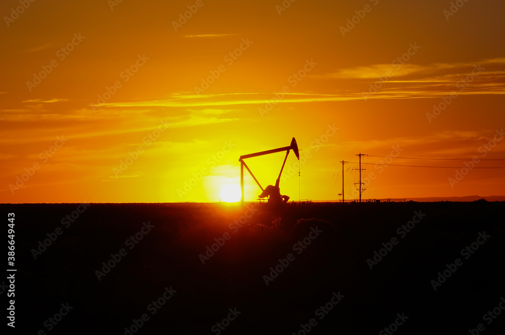 Silhouette Oil pumps at oil field with sunset sky background Silhouette Oil pumps at oil field with sunset sky background