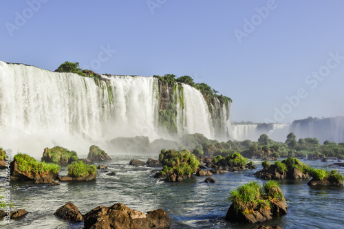 The stunning Iguazu Falls in a beautiful day with blue sky. Foz do Iguaçu, Brazil.