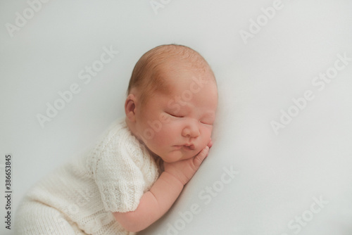 portrait of a little infant newborn baby: baby's face close-up. concept of childhood, healthcare, IVF
