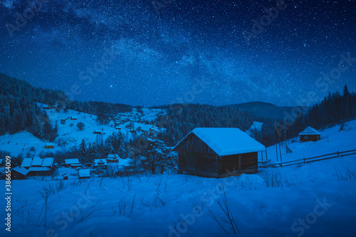 Bright Milky Way in a sky over the alpine winter village