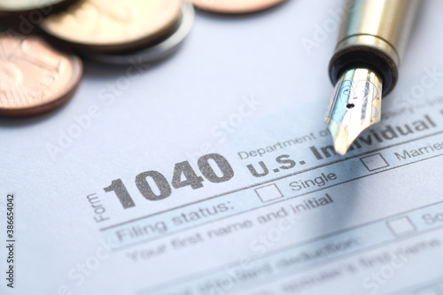 Close up of a Tax return form and pen on table.