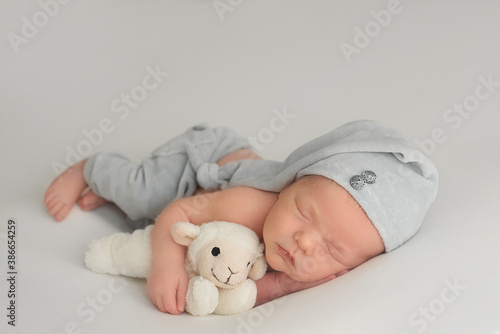 Sleeping newborn girl on a white blanket. Photoshoot for the newborn. 7 days from birth. A portrait of a beautiful, seven day old, newborn baby 