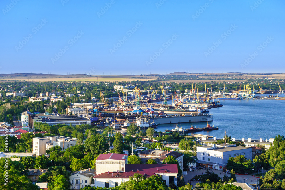 Panorama of sea port with working cranes, docks & ships. Shot in Kerch, Crimea