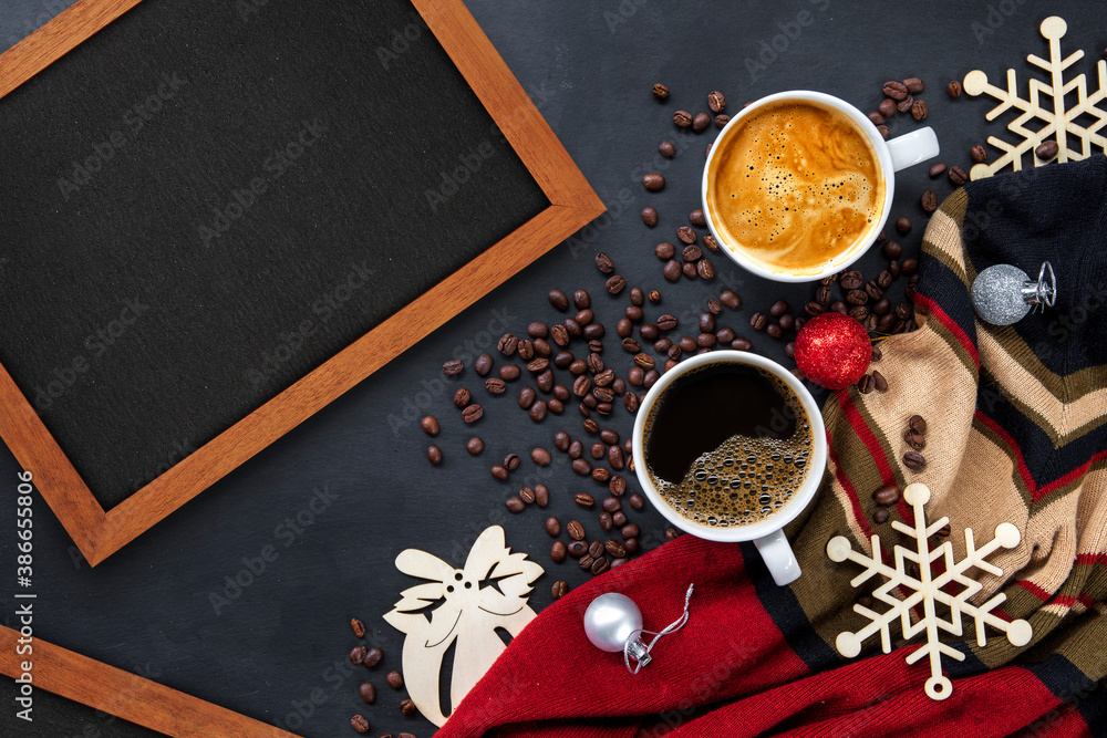 hot coffee and christmas and happy new year day greeting wooden frame on black table background. flat lay