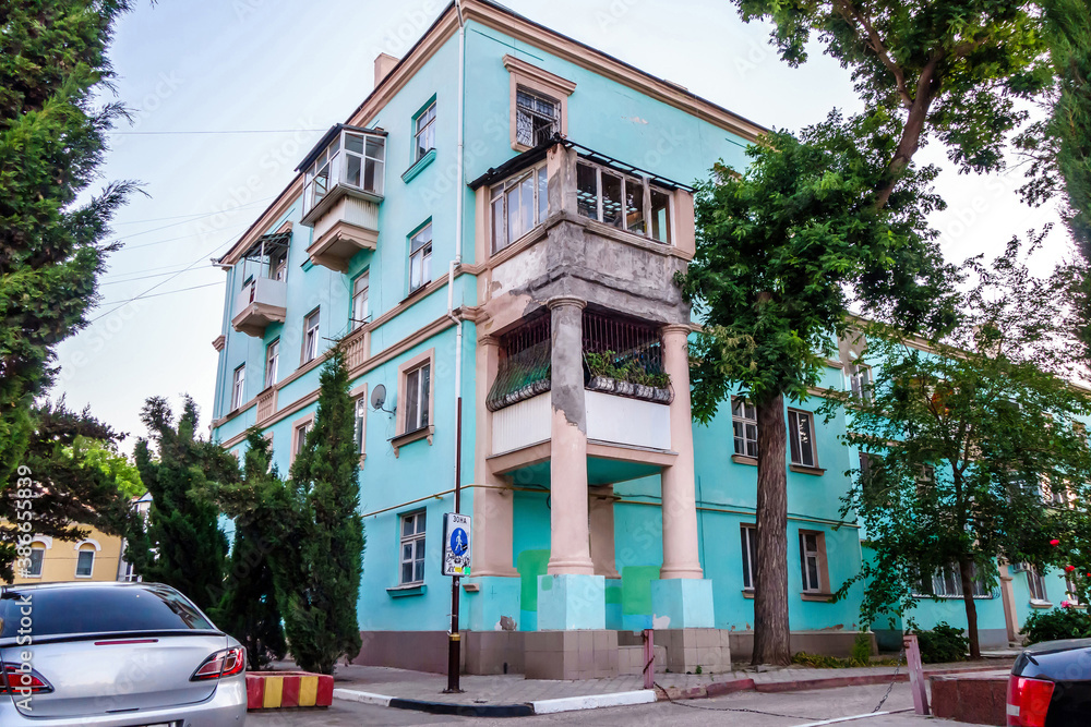 Fototapeta premium Residential house on street of Kerch (Crimea) with an unusual annex in the form of columns and balconies