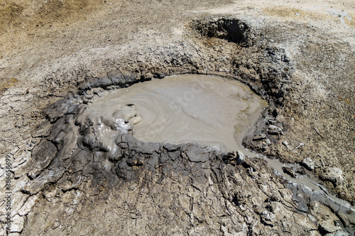 Gas bubble blowing before explode inside crater of mud volcano. Shot in Bulganak field, near Kerch, Crimea