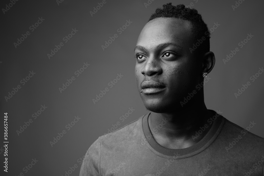 Young handsome African man from Kenya against gray background Young handsome African man from Kenya against gray background