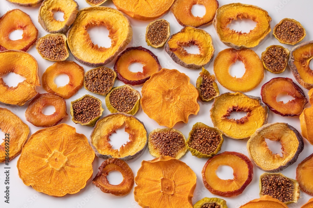 slices of dried persimmon, peach, plum and figs on a white background. dried fruits. eco. slices of dried persimmon, peach, plum and figs on a white background. dried fruits. eco.