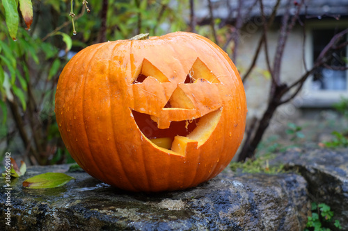 jack o lantern placed on the porch of the house, ready for Halloween