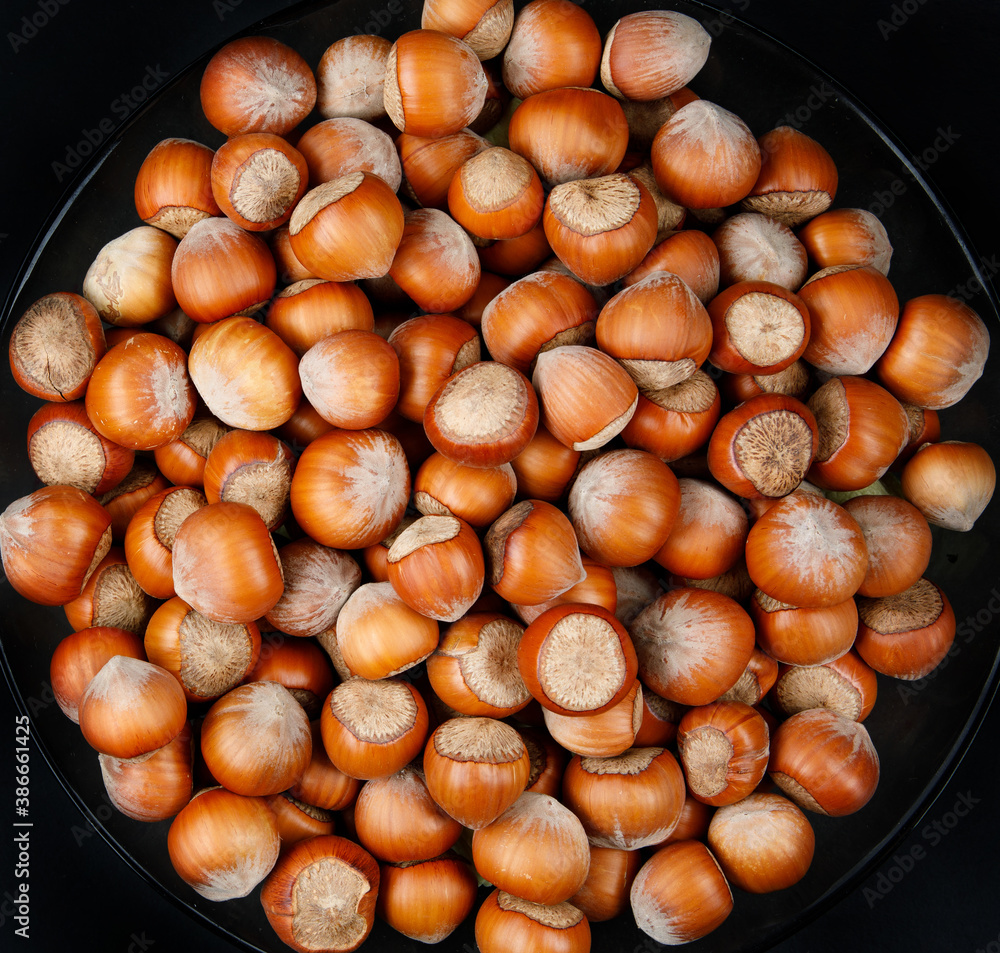 The plate is full of ripe hazelnuts. The plate is full of ripe hazelnuts.