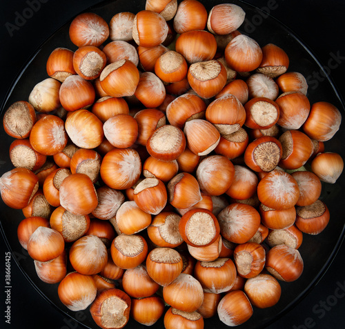 The plate is full of ripe hazelnuts.