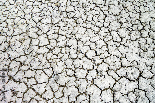 View from above onto dried & cracked earth surface in the desert