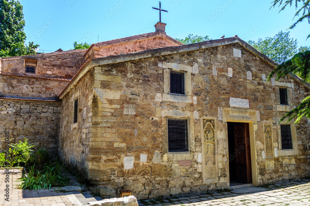 Armenian church Surb Sarkis, Feodosia, Crimea. It was built in XIV AD. Exterior walls decorated by traditional khachkars (crosses). Church is known for fact painter Ivan Ayvazovksy buried in its yard