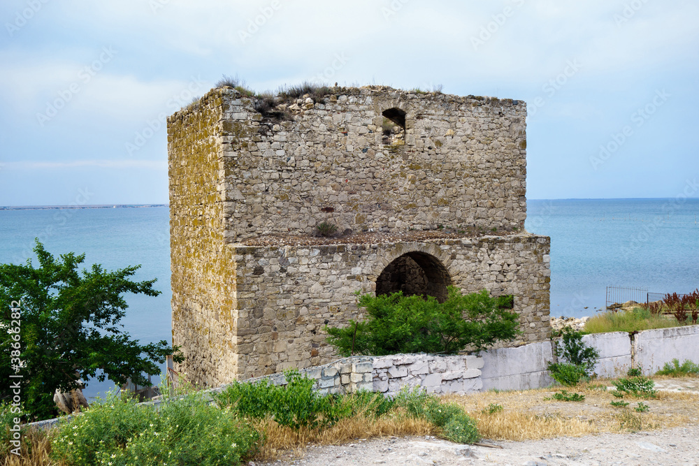 Dock Tower, one of bastions of Genoese fortress, Feodosia, Crimea. In medieval it served as sea gates to castle. Built in XIV century. Black Sea is on background