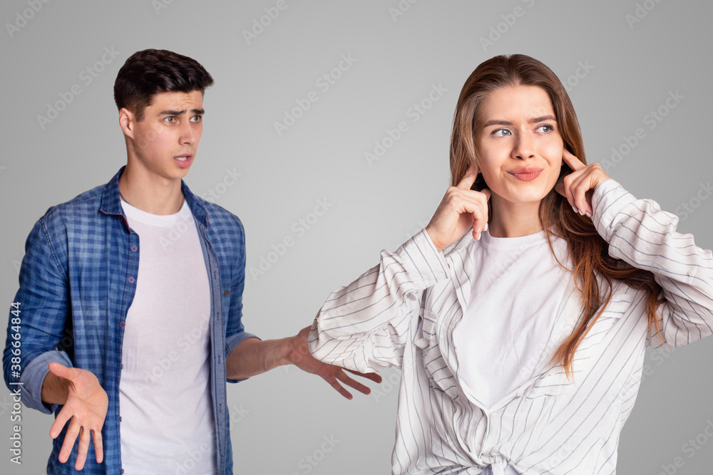 Quarrel and showdown. Sad woman covers her ears with fingers, upset man expresses negative emotions Quarrel and showdown. Sad woman covers her ears with fingers, upset man expresses negative emotions