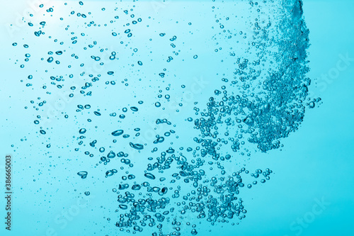Close up of a water and air bubble on blue background.
