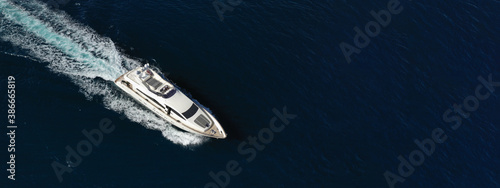 Aerial drone ultra wide photo of luxury yacht with wooden deck cruising in Aegean deep blue sea © aerial-drone
