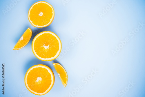 Flat lay. Beautiful background with oranges pieces of citrus on a blue background. Flat lay. Place for text.