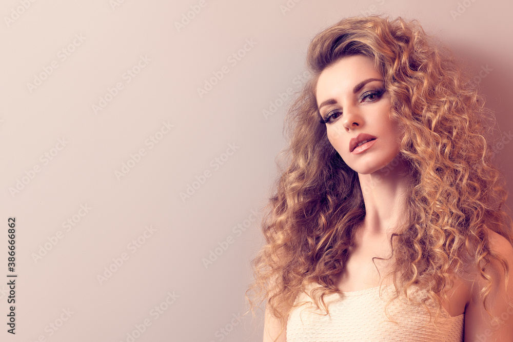 Beauty fashion woman portrait. Gorgeous young blonde with long curly hair healthy skin, makeup. Female face close up. Beautiful smiling model girl, fashionable hairstyle. Skincare make up concept