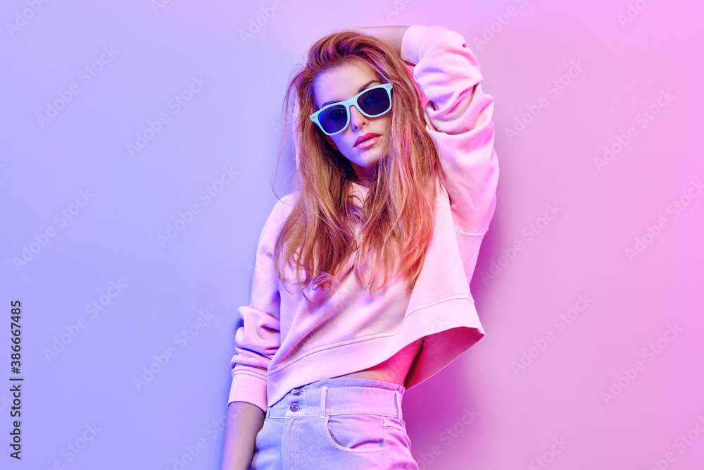 Blive kold Gør det godt mikrobølgeovn Fashionable hipster woman in Trendy outfit, stylish hair, makeup on pink  purple neon light. Redhead model in hoodie, fashion jeans, sunglasses.  Beautiful bad sexy girl in neon style Stock Photo | Adobe