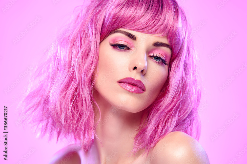 Naklejka premium Beauty Fashion woman with Colorful Pink Dyed Hair. Girl with blue eyes, perfect Makeup and Hairstyle. Beautiful smiling model portrait, fashionable pink make up, hair. Skincare concept