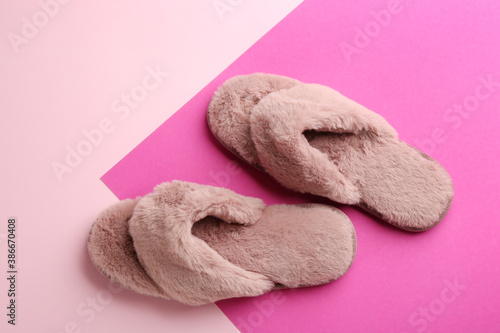 Pair of stylish soft slippers on color background, flat lay