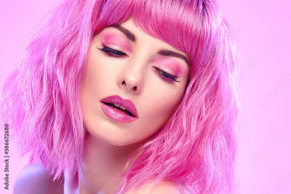 Beauty Fashion woman with Colorful Pink Dyed Hair. Girl with blue eyes, perfect Makeup and Hairstyle. Beautiful smiling model portrait, fashionable pink make up, hair. Skincare concept