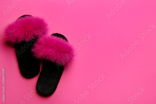 Pair of soft slippers on pink background, flat lay. Space for text