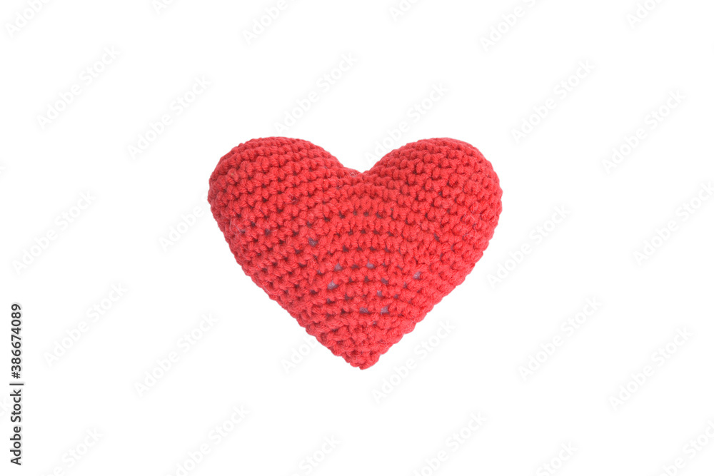 Product knitted from red yarn in the shape of a heart isolated on a white background.