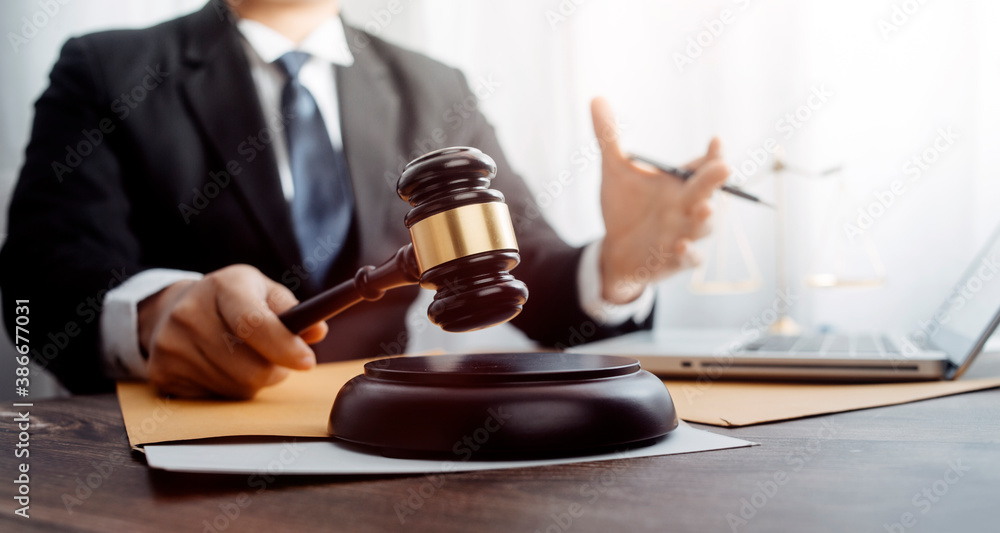 Business and lawyers discussing contract papers with brass scale on desk in office. Law, legal services, advice, justice and law concept picture with film grain effect Business and lawyers discussing contract papers with brass scale on desk in office. Law, legal services, advice, justice and law concept picture with film grain effect