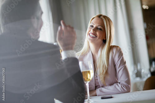 Beautiful businesswoman drinking wine. Businesswoman enjoying in the restaurant.