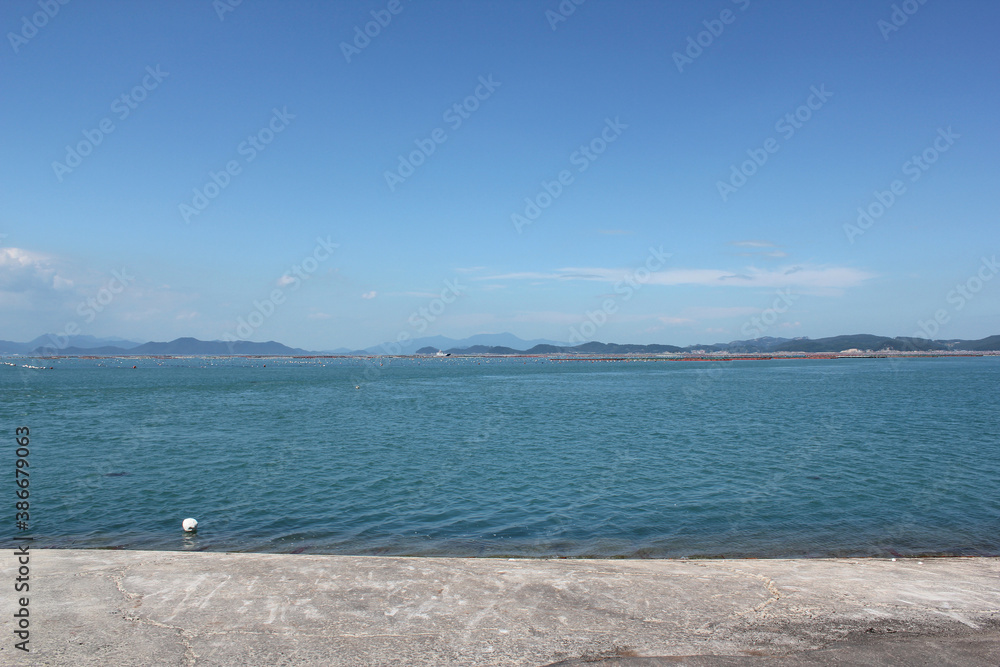 empty concrete floor and blue sea in blue sky