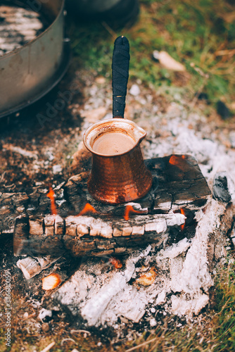 A photo of a burning wood under a turkish coffee pot