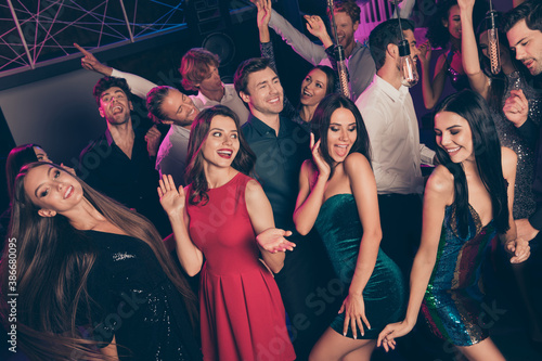 Photo portrait of guys and girls having fun fooling together on dance floor at night club