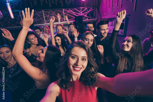 Self photo portrait of girl and friends dancing raising hands