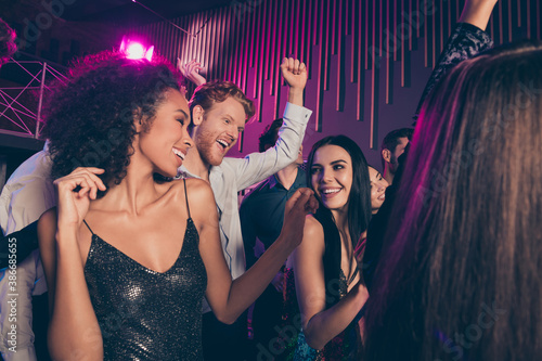 Low angle photo of young students company dancing at night club celebrating prom party together wearing festive clothes laughing smiling