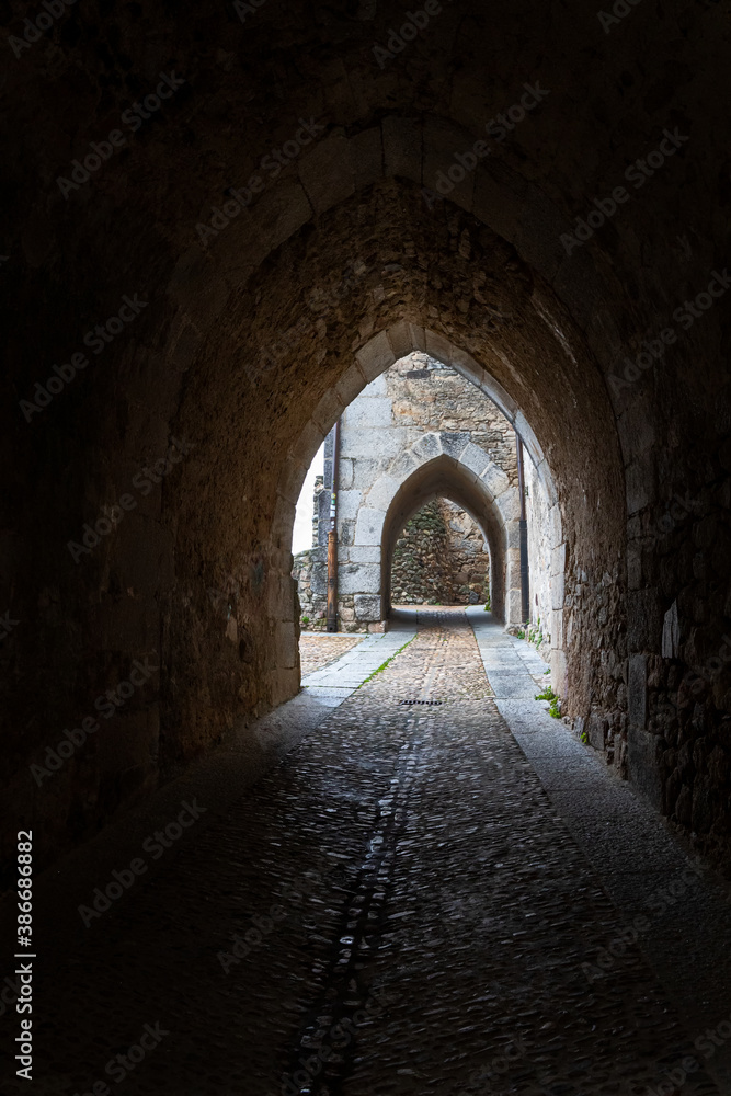 Narrow street with Gothic arches located in the historic town of Miranda del Castañar. Spain.