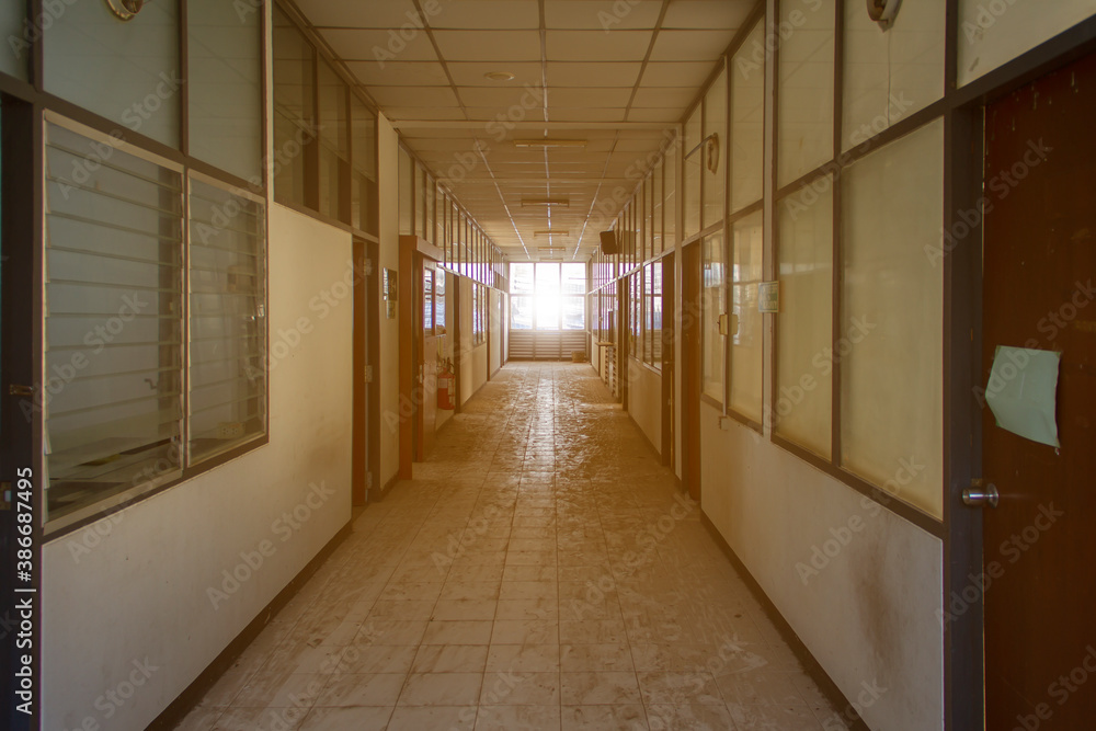 Aisle in a dilapidated building that shines in the twilight Lonely horror concept
